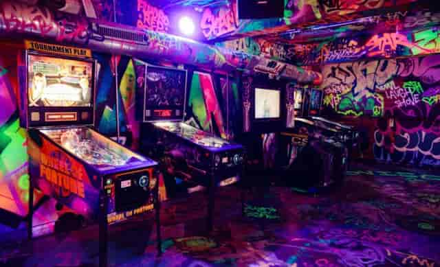 Vibrant graffiti arcade with pinball machines for team-building and casual gatherings