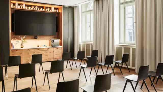 Andaz Studio 1 2 3 in Prague: minimalist meeting space with black chairs for workshops.