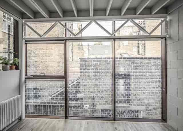 Modern Green Room at Holborn House, ideal for meetings and events with natural light.