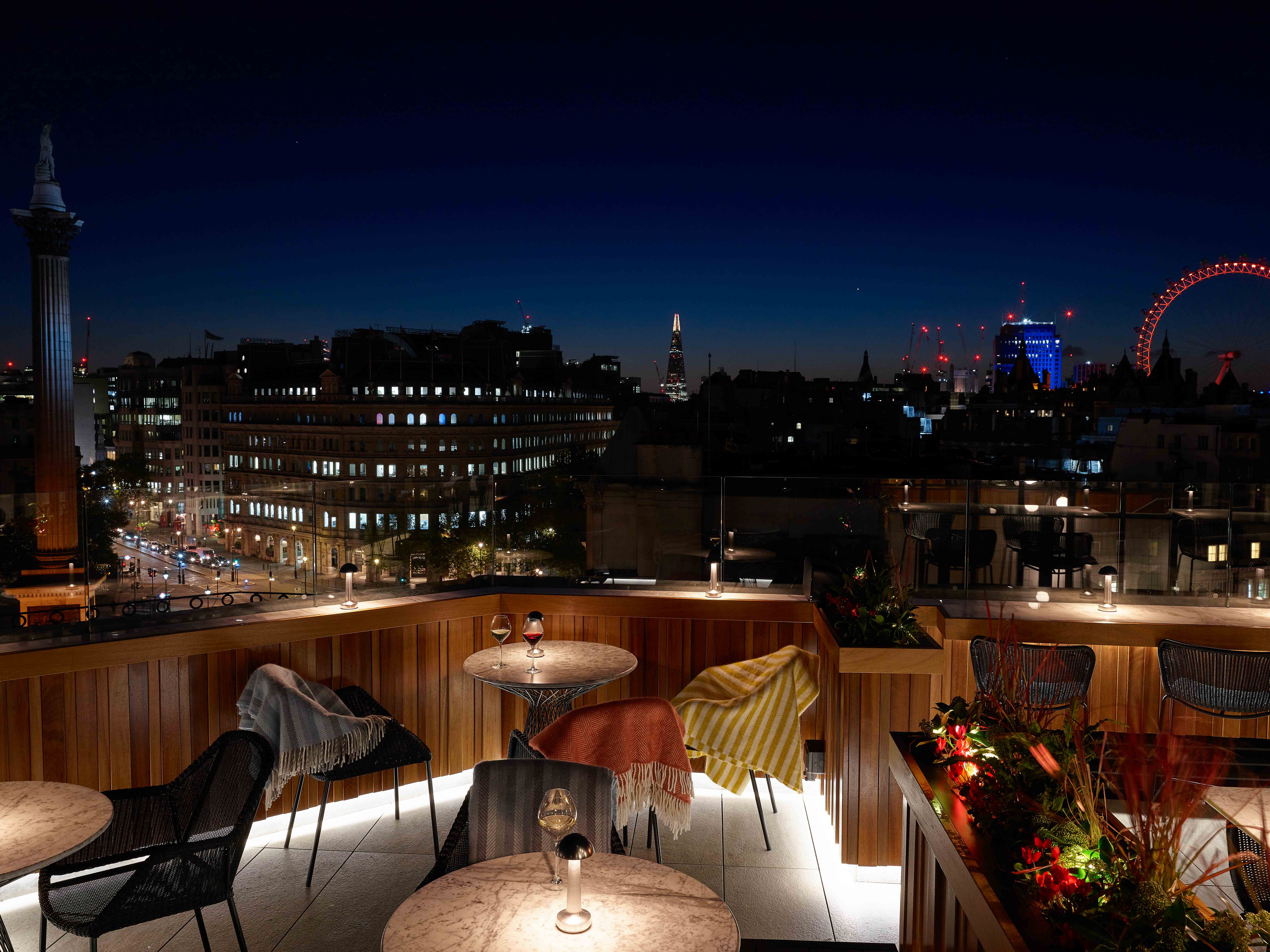 "Christmas party at Trafalgar St James Rooftop with city skyline and warm lighting." - Banner