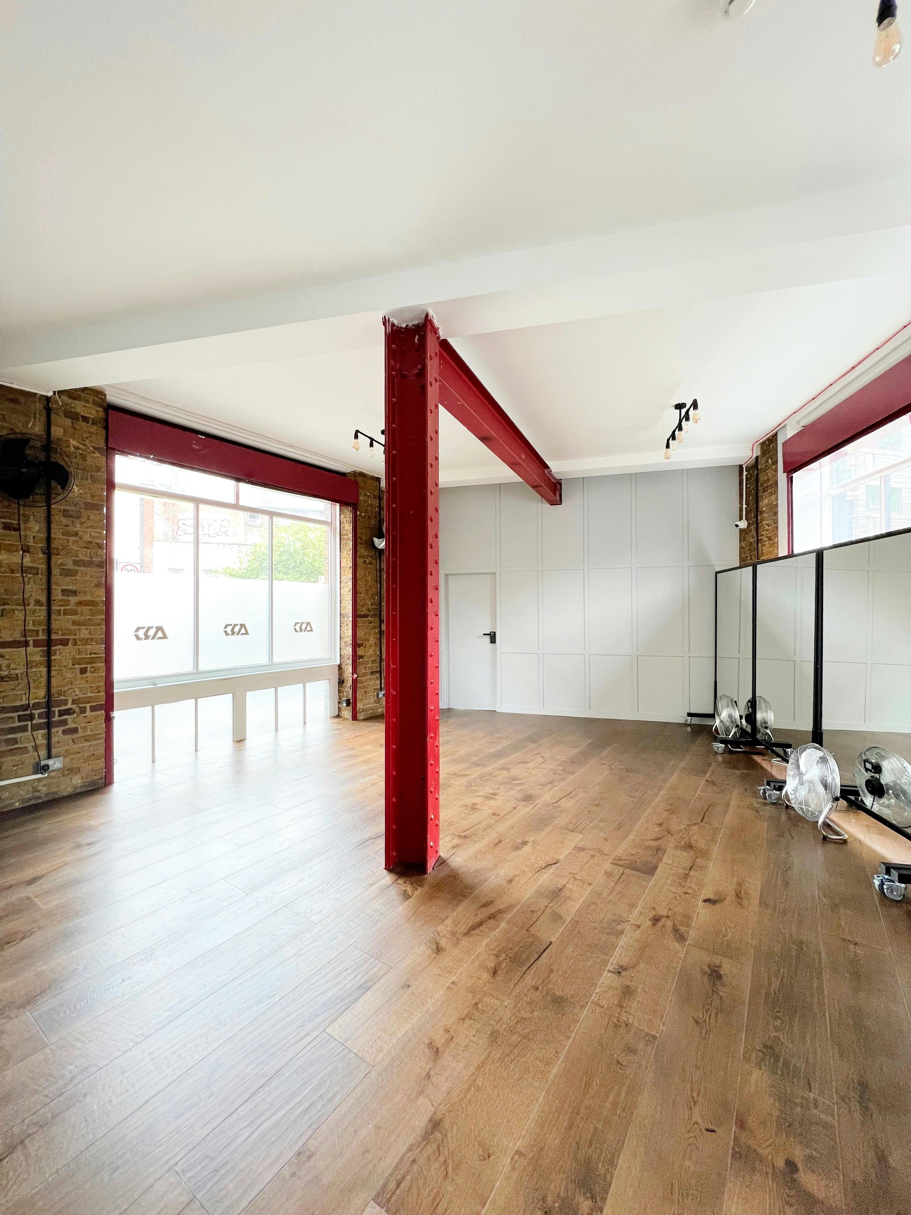 Versatile event space with large windows, ideal for workshops and meetings at ARC STUDIOS.