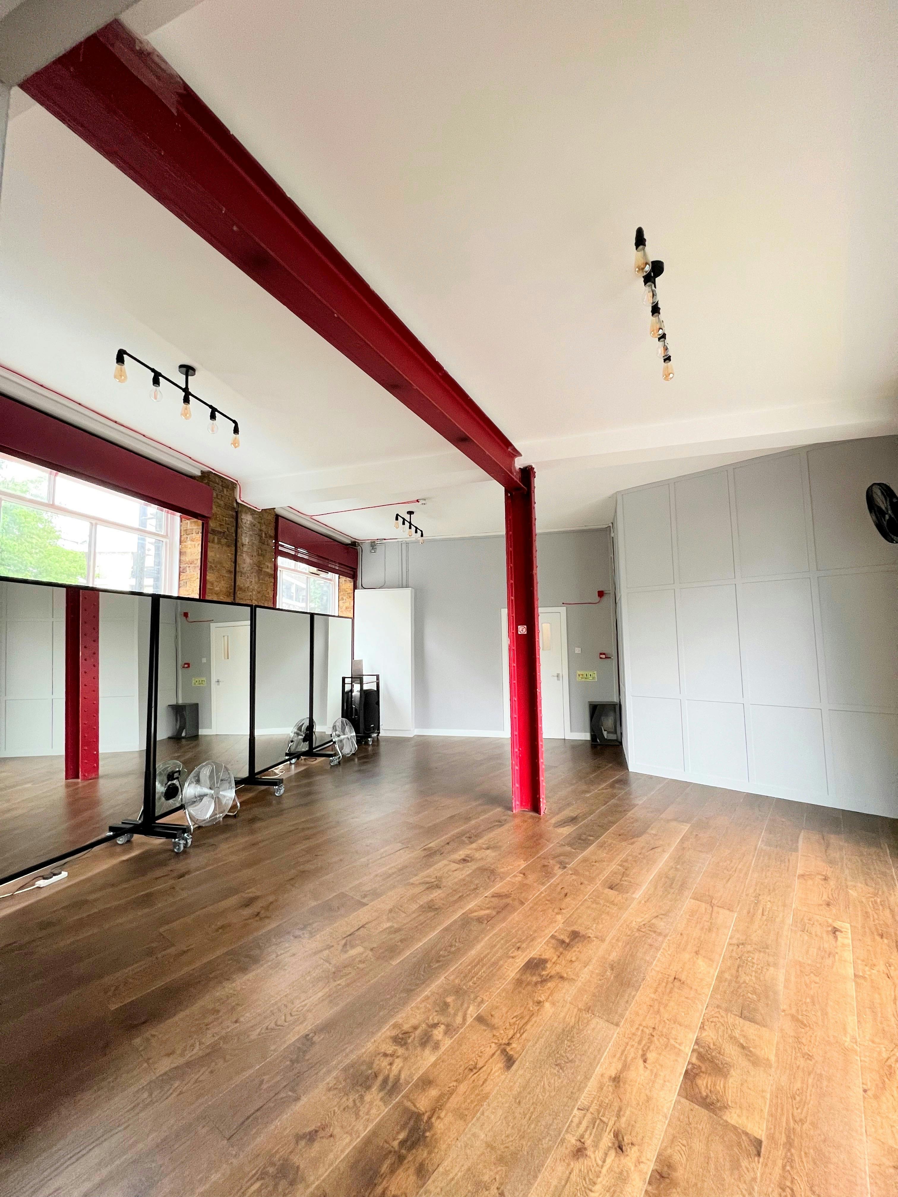 Versatile event space with hardwood floors and natural light for workshops and gatherings.