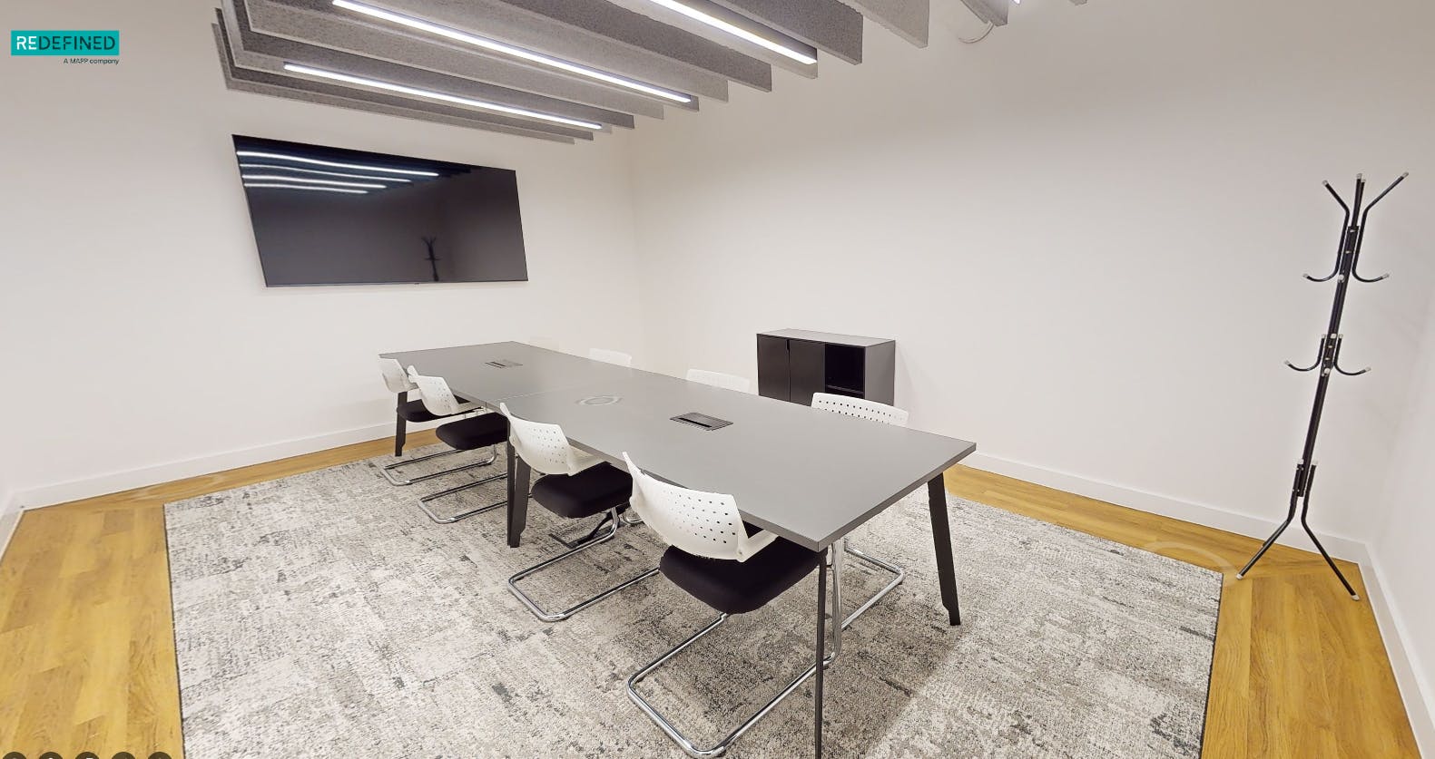 Modern meeting room in Louisa Ryland House, featuring a sleek table and collaborative design.