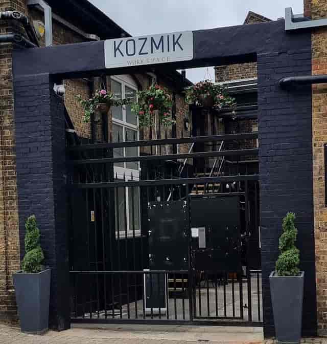 Modern outdoor meeting room entrance with floral decor, ideal for urban events.