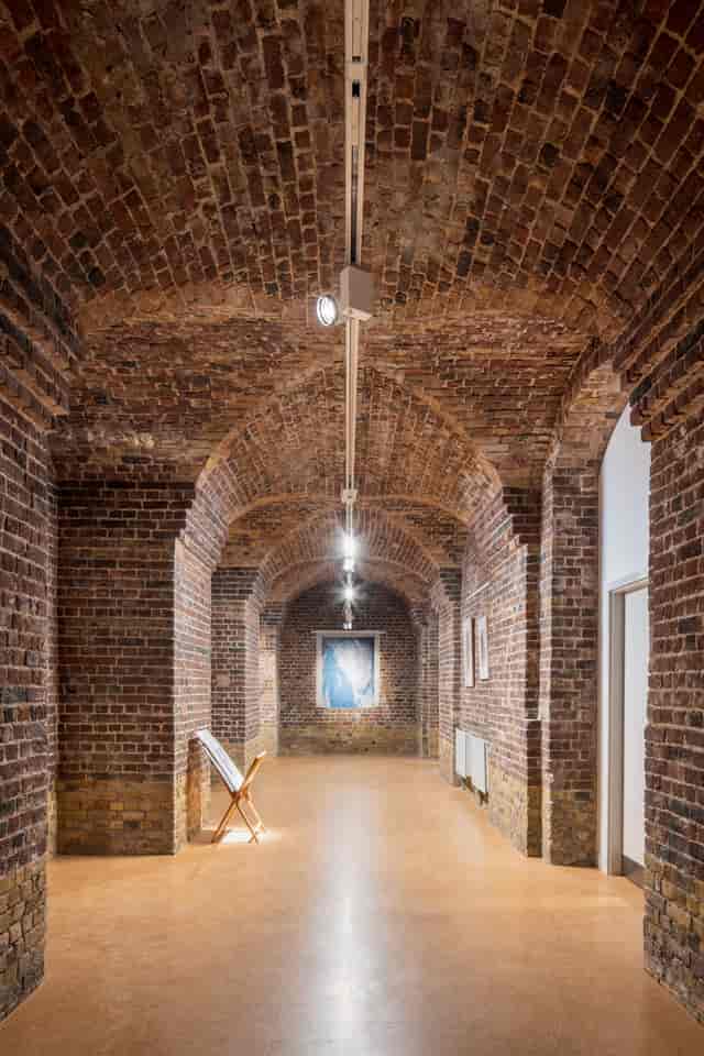 Old Crypt in St John's Church Waterloo with brick archway, perfect for events and art exhibitions.