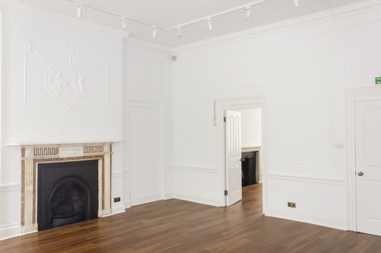 Elegant Morrell Room with fireplace, ideal for meetings and workshops in Bloomsbury.