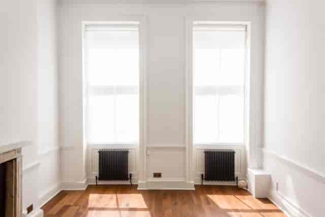 Bright minimalist event space in Otto Room, featuring large windows for natural light.