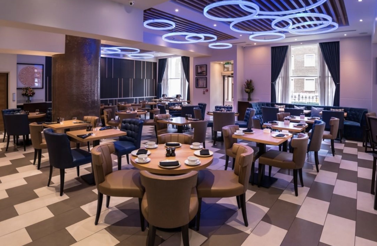 Modern dining space at Norfolk Towers, ideal for networking events and private dinners. - Banner