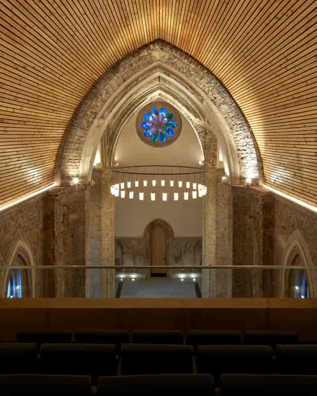 Elegant event space in Abney Park Chapel with vaulted ceilings and stained glass.