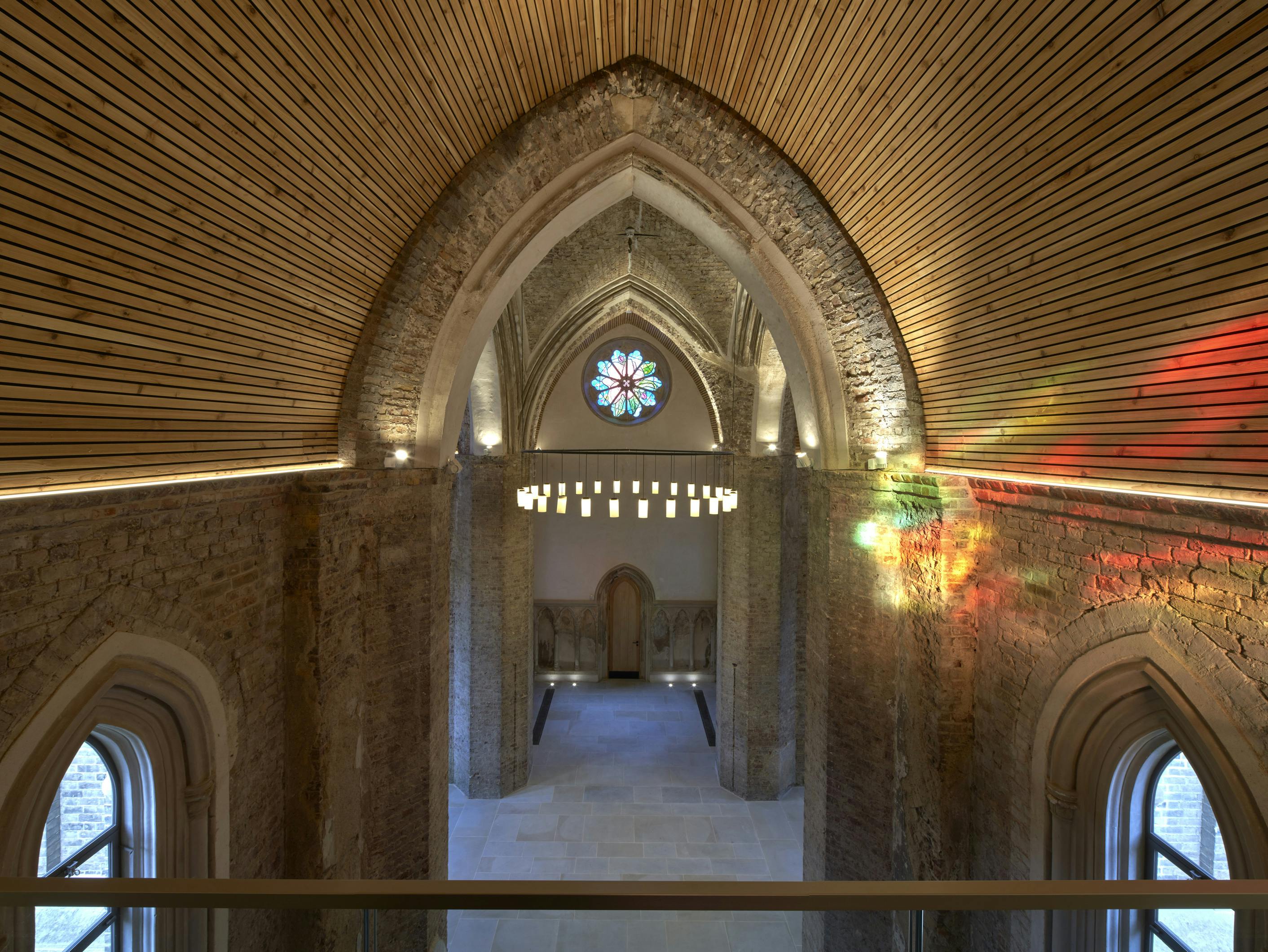 Elegant event space in Abney Park Chapel with high arched ceilings and stained glass.