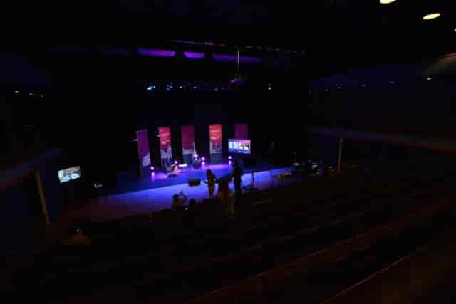 Spacious ICC Belfast studio with vibrant stage lighting for presentations and performances.