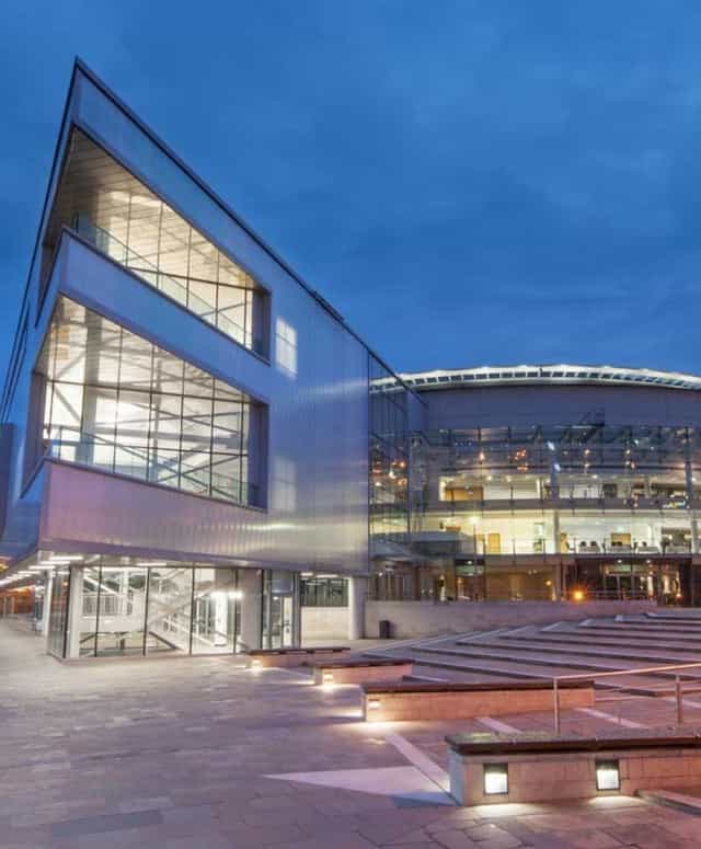 Café Parisien at ICC Belfast, modern venue with glass facades for conferences and events.