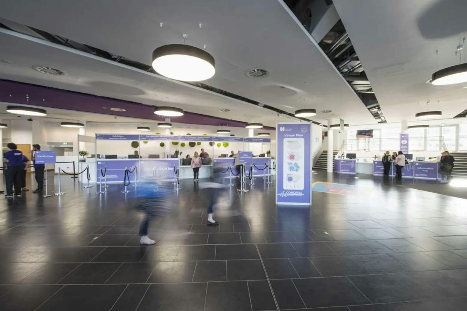 Riverside Foyer at ICC Belfast, modern event registration area with check-in counters.