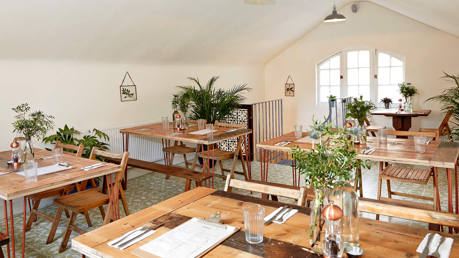 Private dining room with rustic tables, ideal for intimate gatherings and workshops. - Banner