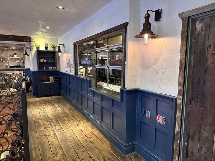Rustic-modern venue with wooden flooring, perfect for networking events and gatherings.