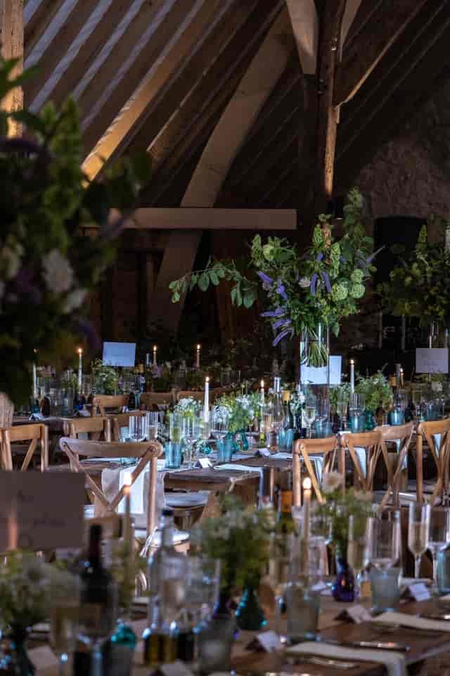 Ruffynes Barn event space with rustic tables, floral centerpieces for weddings and gatherings.