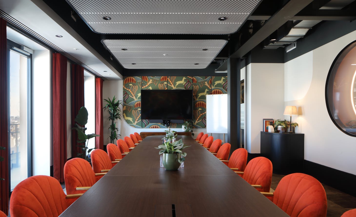 Modern conference room with vibrant orange chairs for impactful meetings and presentations.