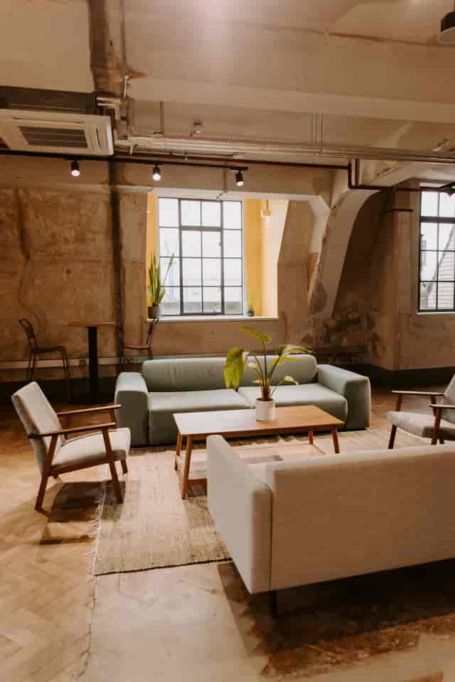 Stylish meeting space with natural light and greenery for informal gatherings.