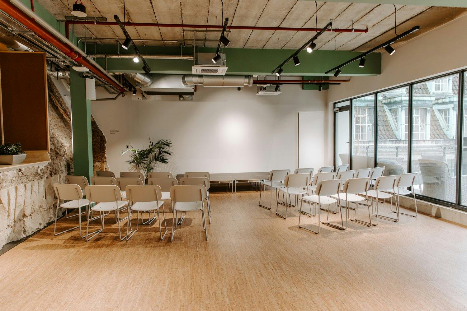 Versatile event space with natural light for meetings and presentations at Sustainable Ventures.