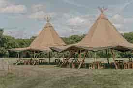 Stylish tipis in serene outdoor setting, perfect for unique events and gatherings.