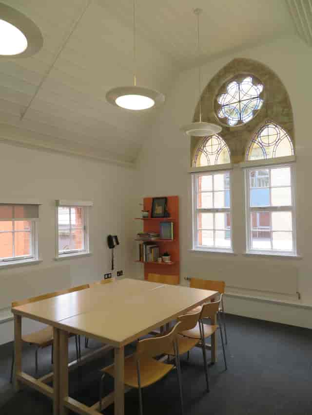 Bright meeting space in Ikon Gallery with large table, ideal for workshops and discussions.