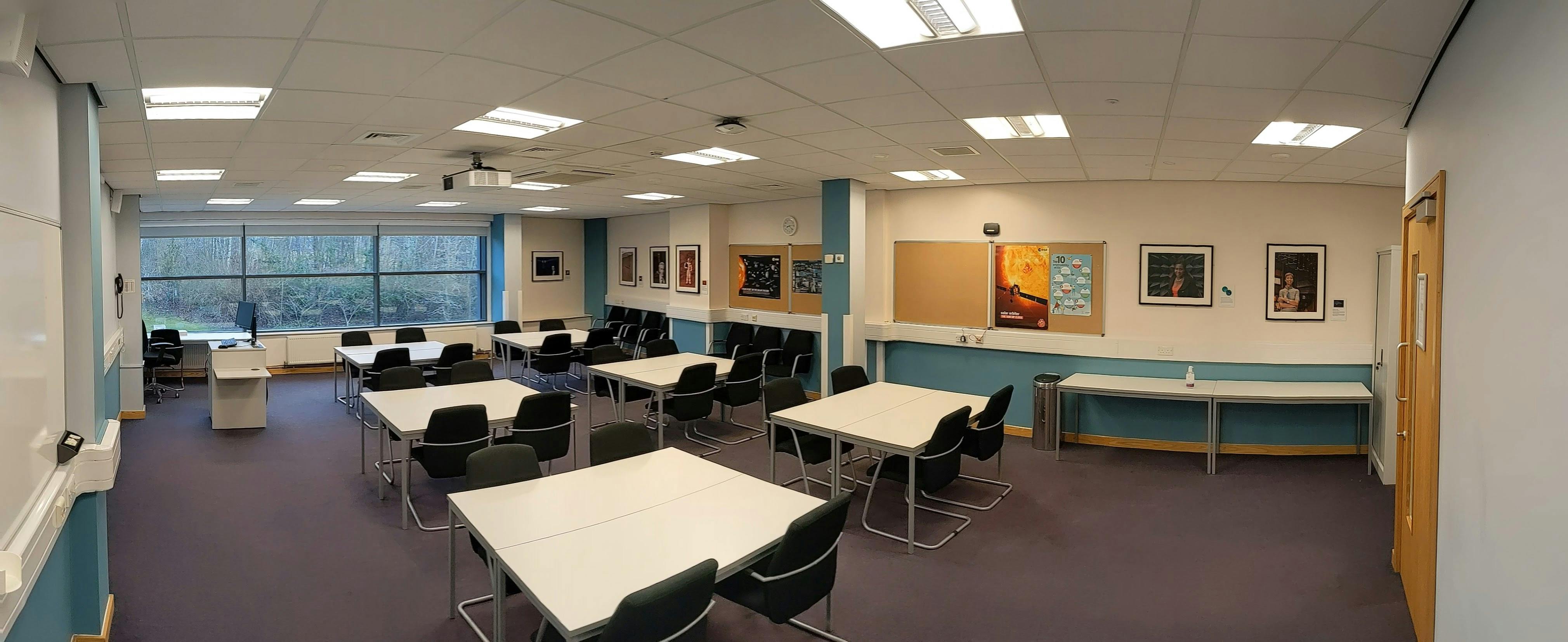 Versatile teaching room with flexible seating for STEM workshops and presentations.