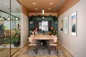 Modern meeting room with large table, glass walls, ideal for corporate events.