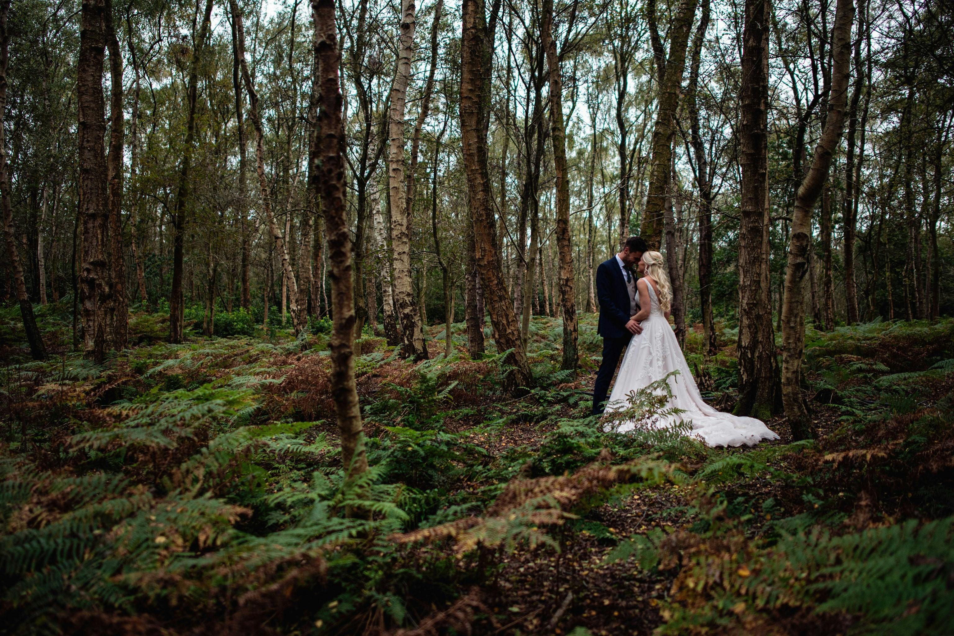 Couple in serene forest venue, perfect for outdoor weddings and elopements.