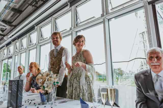 Elegant wedding setup in Wolfson Auditorium, Jodrell Bank, with joyful couple and natural light.