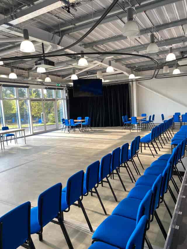 Wolfson Auditorium with blue chairs, ideal for meetings and workshops at Jodrell Bank.