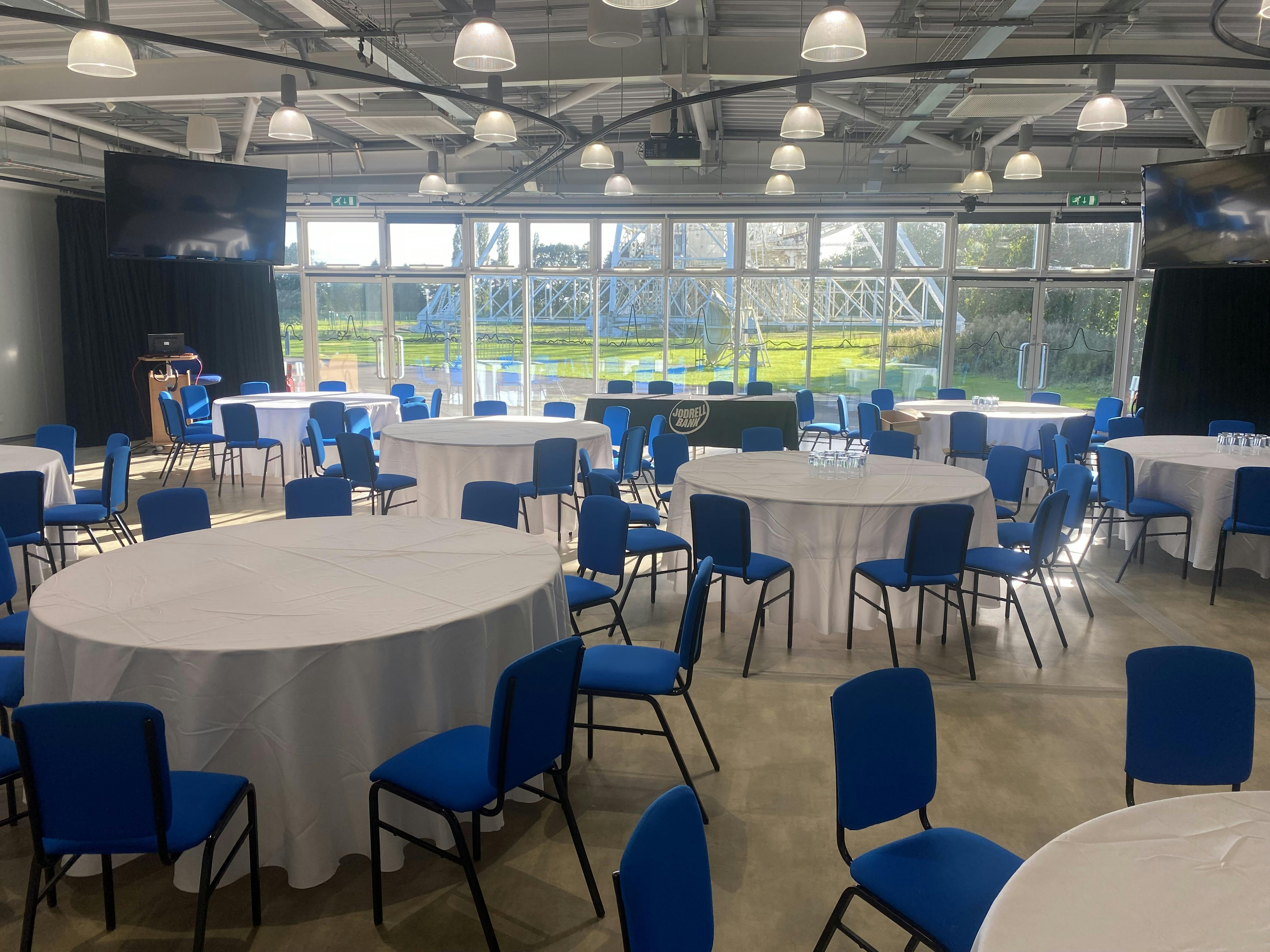 Wolfson Auditorium event space with round tables, ideal for conferences and workshops.