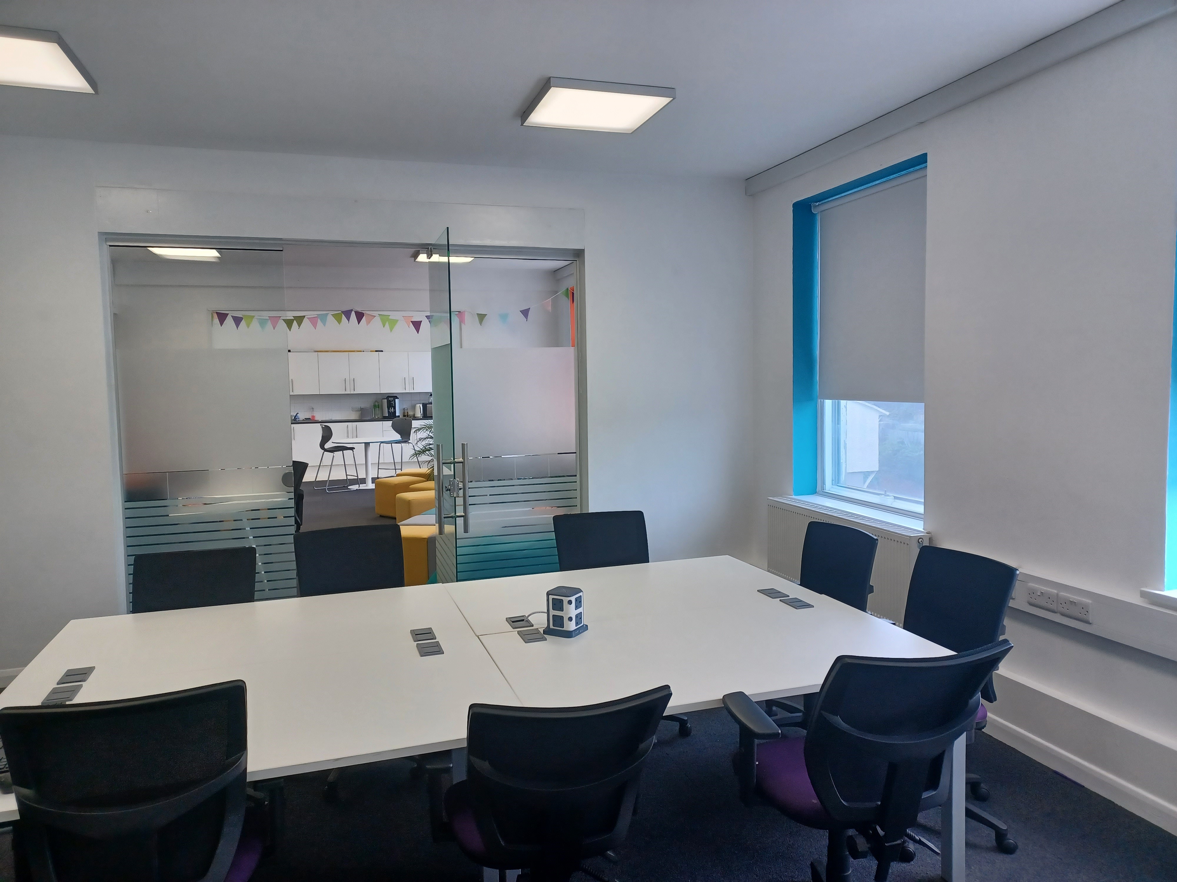 Modern meeting room at BSC Brighton with spacious table, ideal for team discussions. - Banner