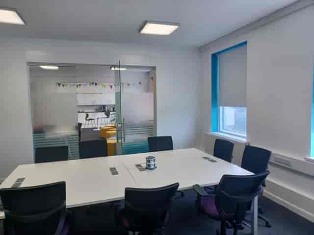 Modern meeting room at BSC Brighton with spacious table, ideal for team discussions.