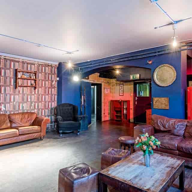 Cozy Theatre Space with leather seating, perfect for intimate workshops and networking events.