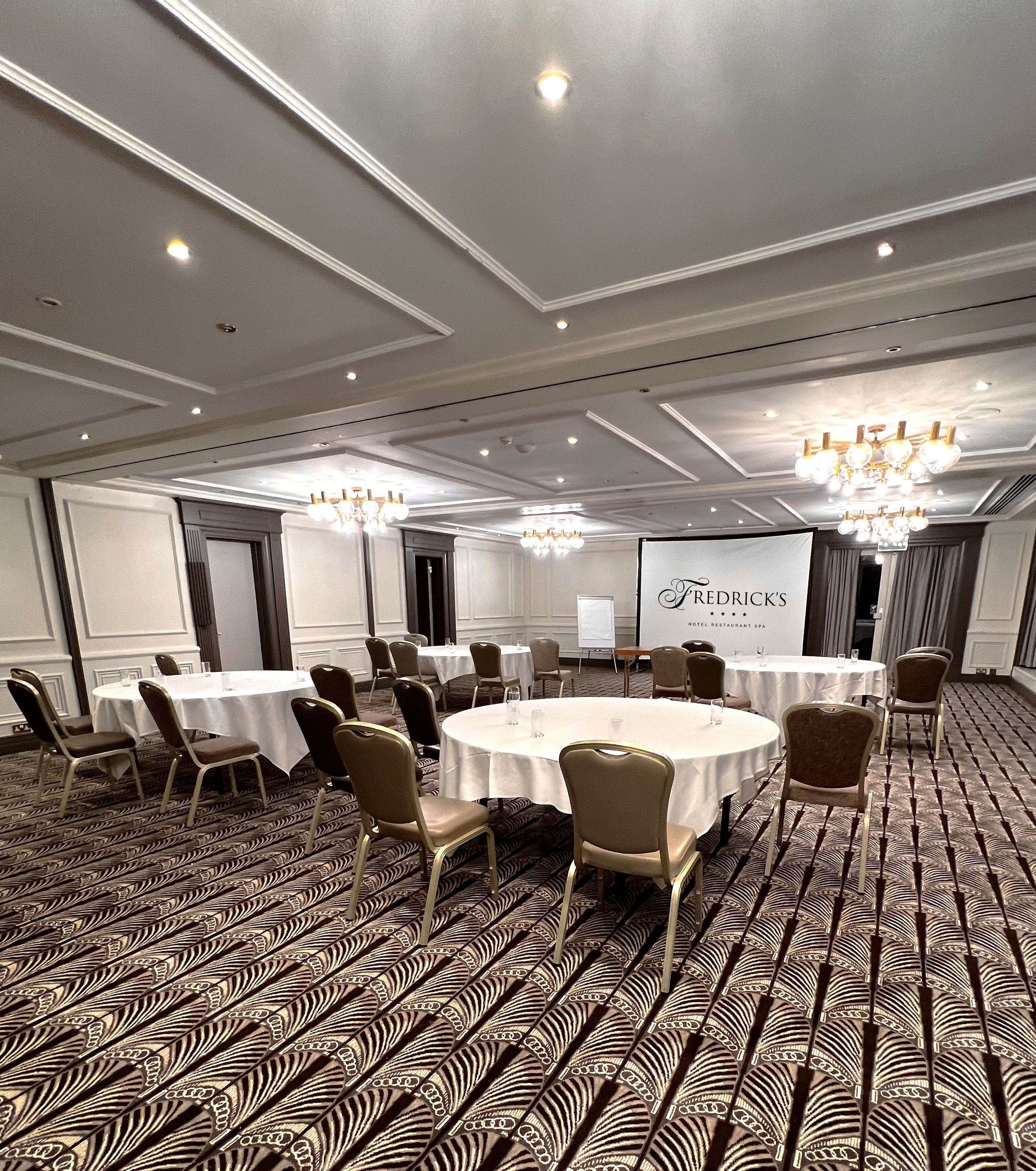 Fredrick's Suite meeting room with round tables, ideal for corporate events and seminars. - Banner