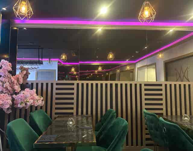 Stylish Maharani Lounge with mirrored wall, plush seating for upscale events.