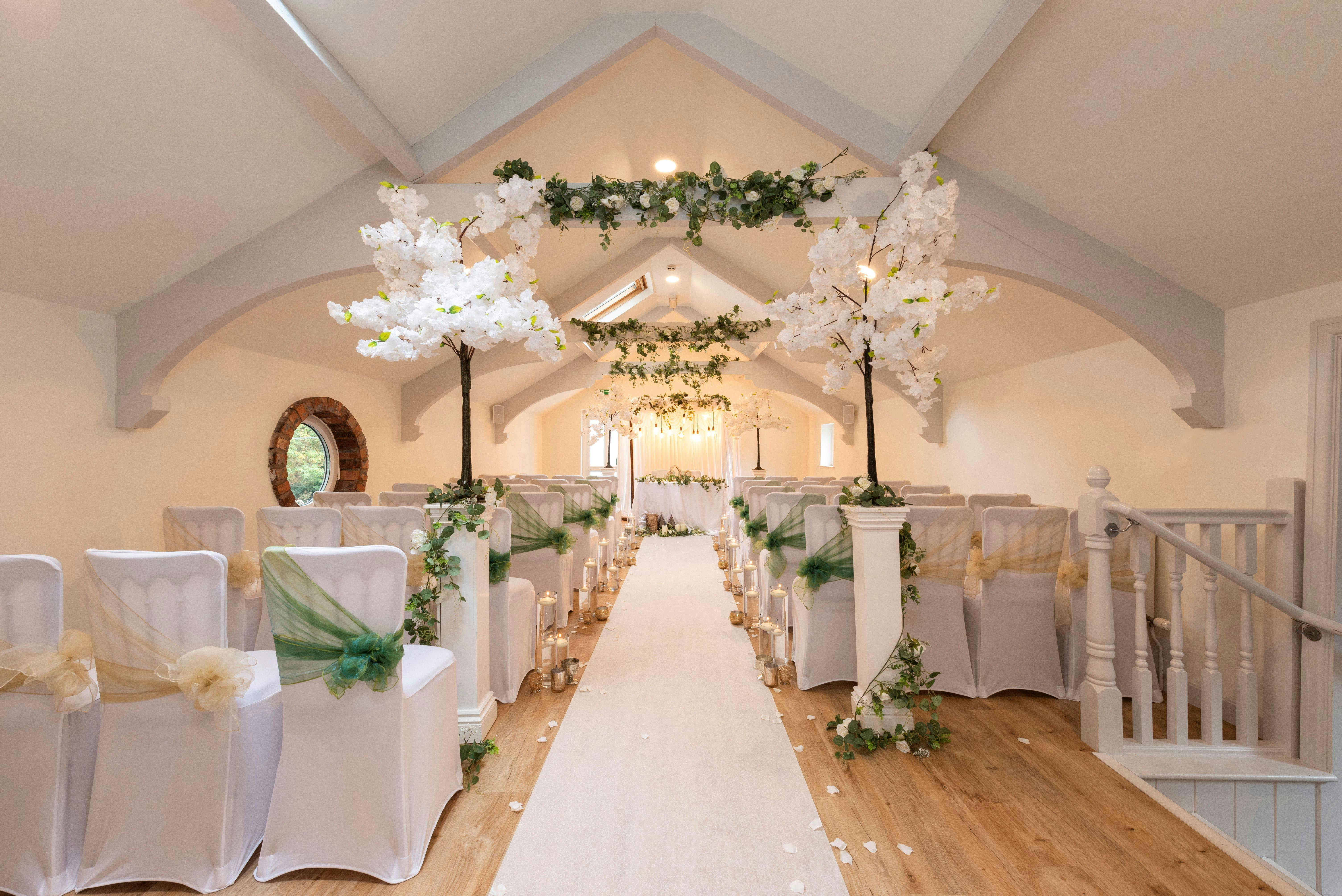 Elegant Bluebell Suite wedding venue with white decor and floral accents.