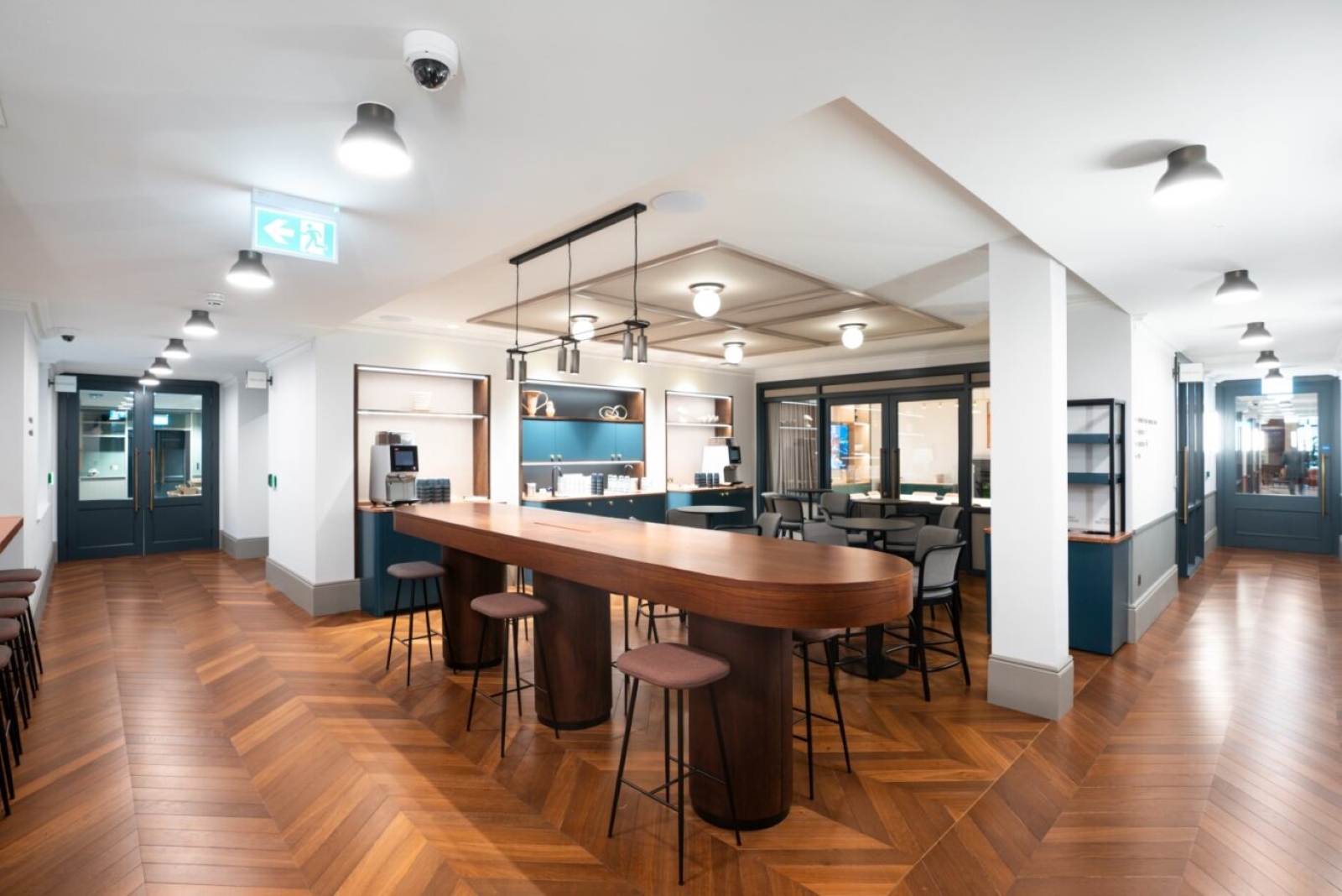 Modern meeting space with bar-style table for networking events at Salisbury House. - Banner