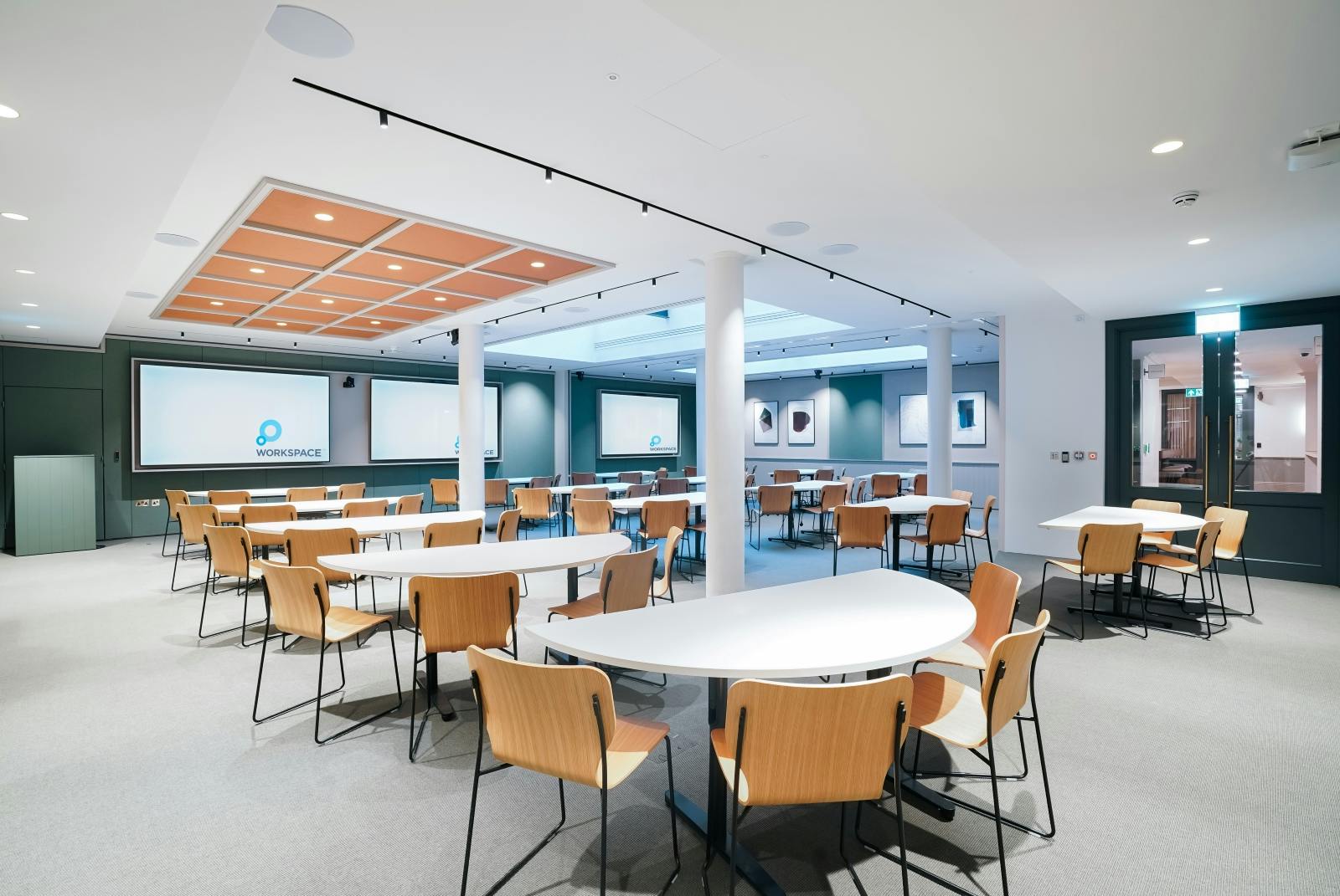 Versatile meeting space with natural light for corporate workshops and presentations.