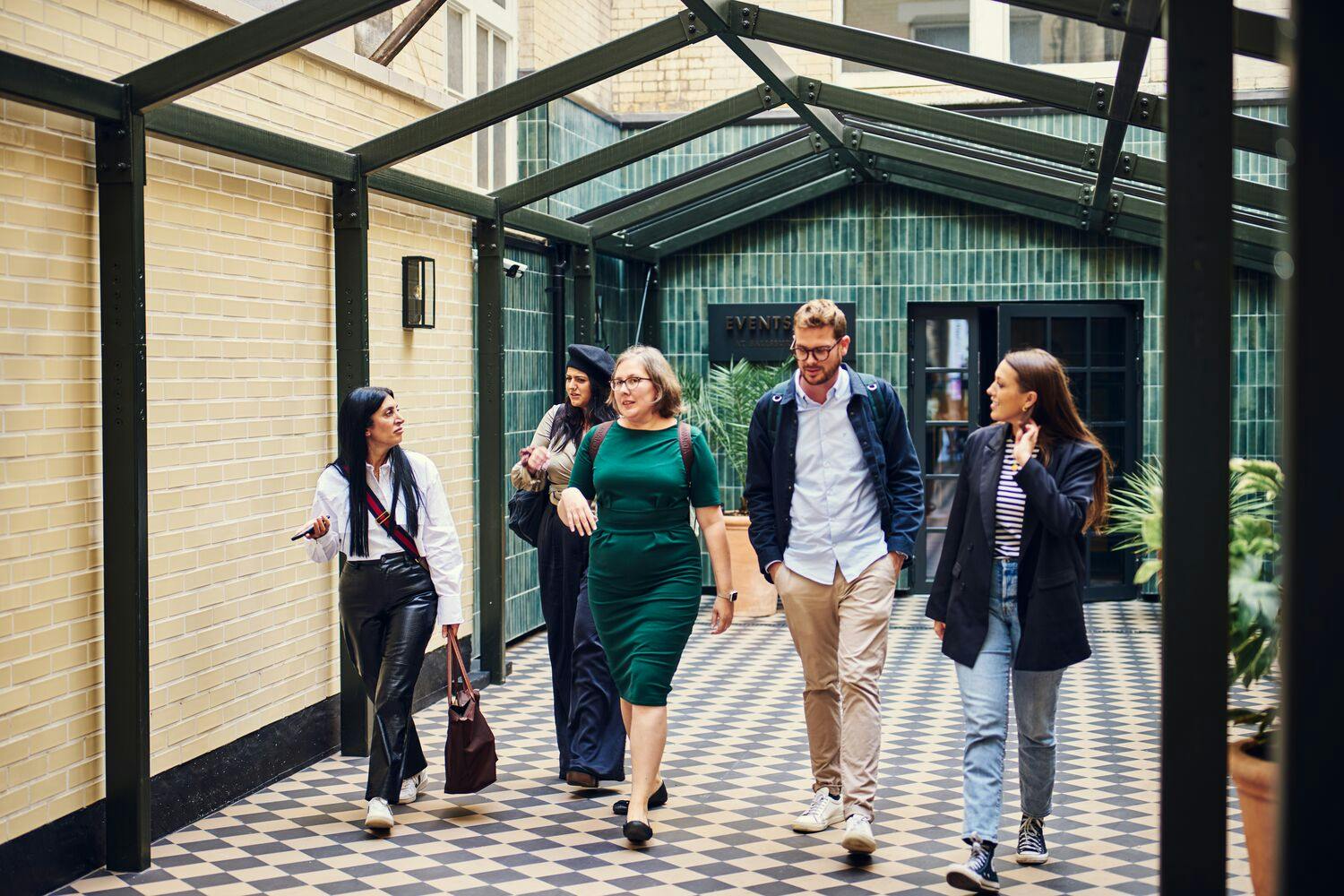 Professionals networking in a stylish corridor at Salisbury House event space.
