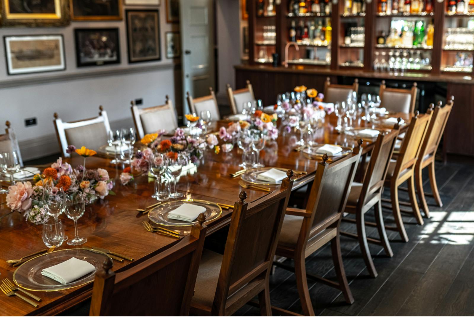 Elegant dining table with floral centerpieces at Pickle Room, ideal for corporate events.