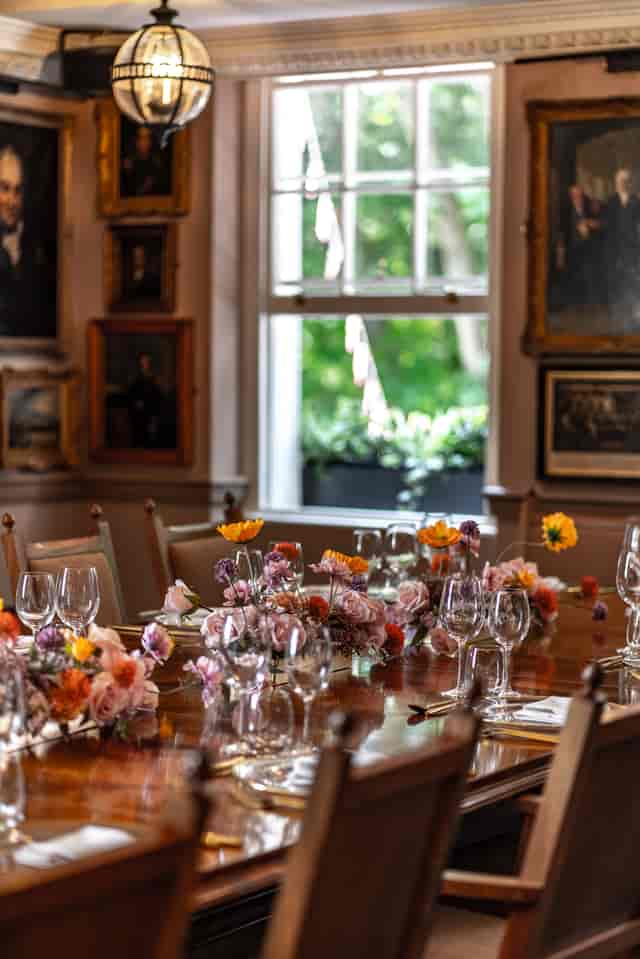 Elegant dining table with floral arrangements at Pickle Room, ideal for upscale events.