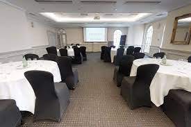 Meeting room setup with round tables for corporate events at Mercure Exeter Southgate Hotel.