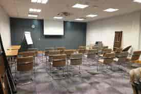 Meeting room in Leonardo Hotel Exeter, featuring a central screen for presentations.