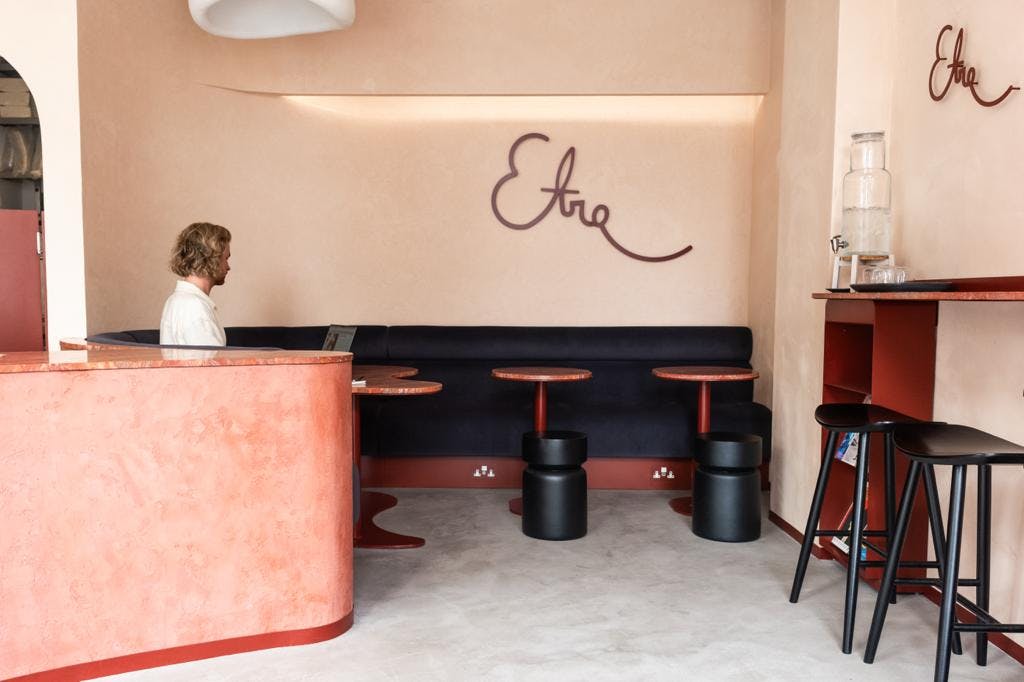 Modern minimalist meeting space with warm colors, ideal for brainstorming and client discussions.