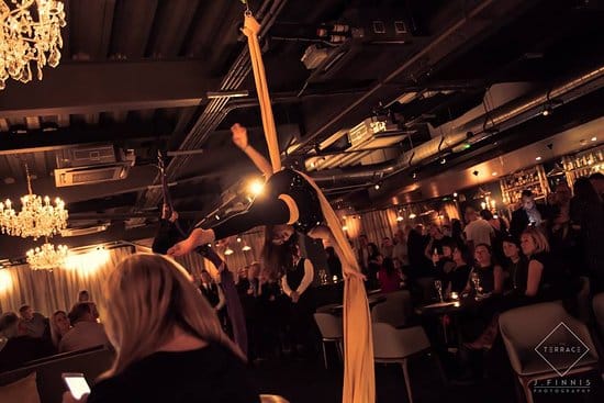 Aerial performers in elegant event space at The Club, perfect for corporate gatherings.
