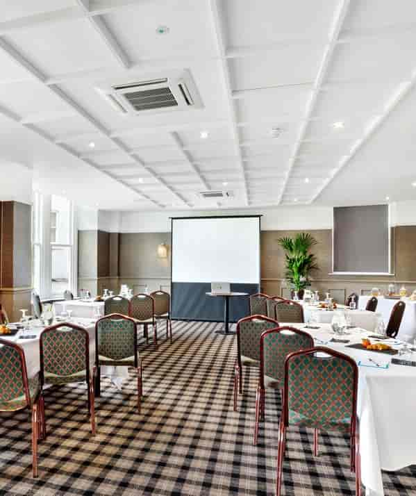Harrogate Town Suite meeting room with presentation screen, ideal for corporate events.