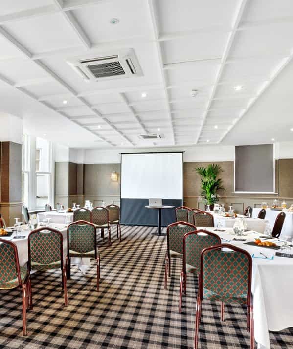 Harrogate Town Suite meeting room with presentation screen, ideal for corporate events.