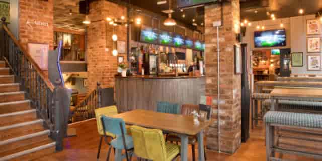 Vibrant venue with rustic brick walls, ideal for networking events and casual meetings.