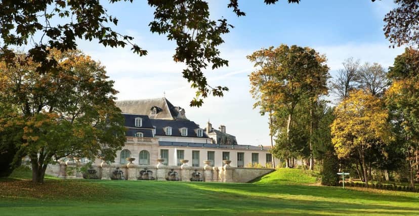 Elegant chateau venue in lush greenery, perfect for weddings and corporate events.